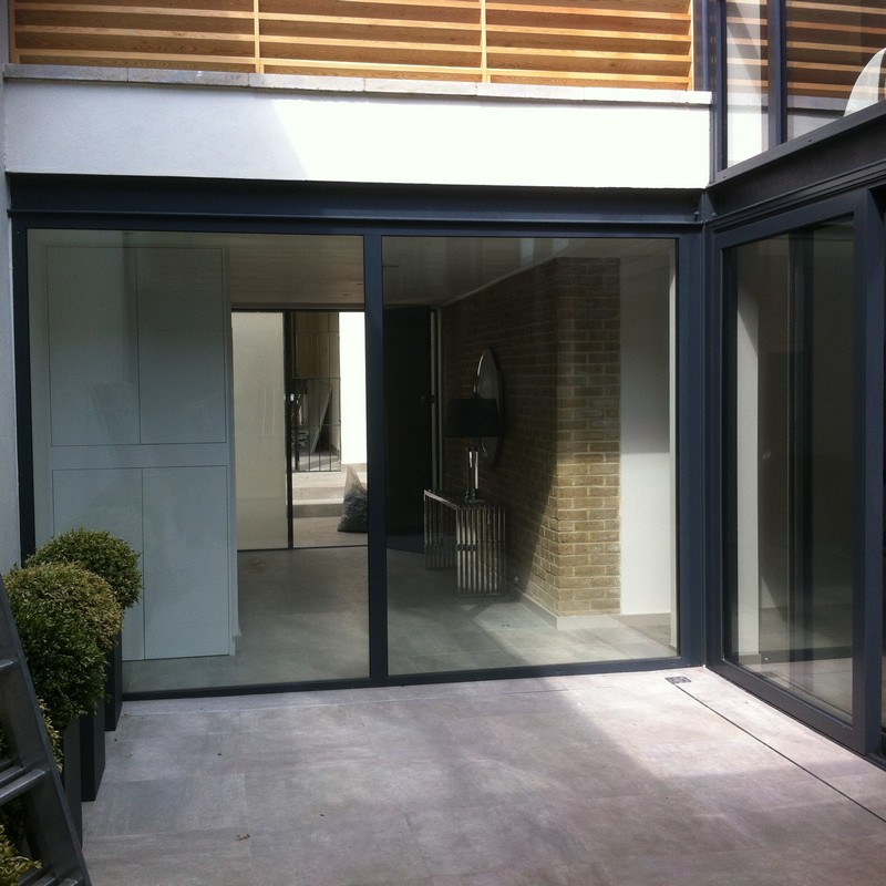 Floor-to-ceiling sliding doors opening to courtyard in Hanwell