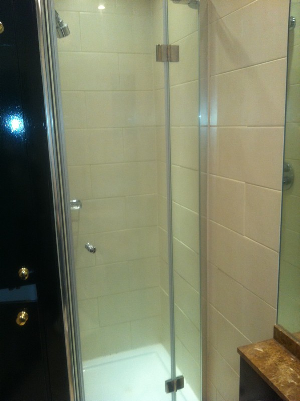 Frameless glass shower enclosure with chrome fittings in Hanwell