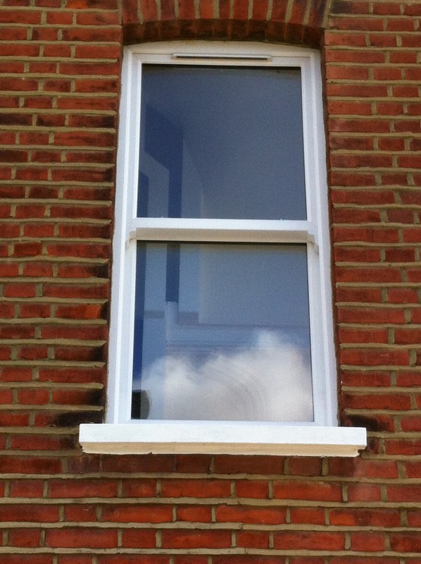 uPVC sash window on Victorian red brick house in Hanwell